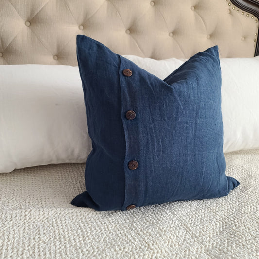 Blue linen pillow on the white bed